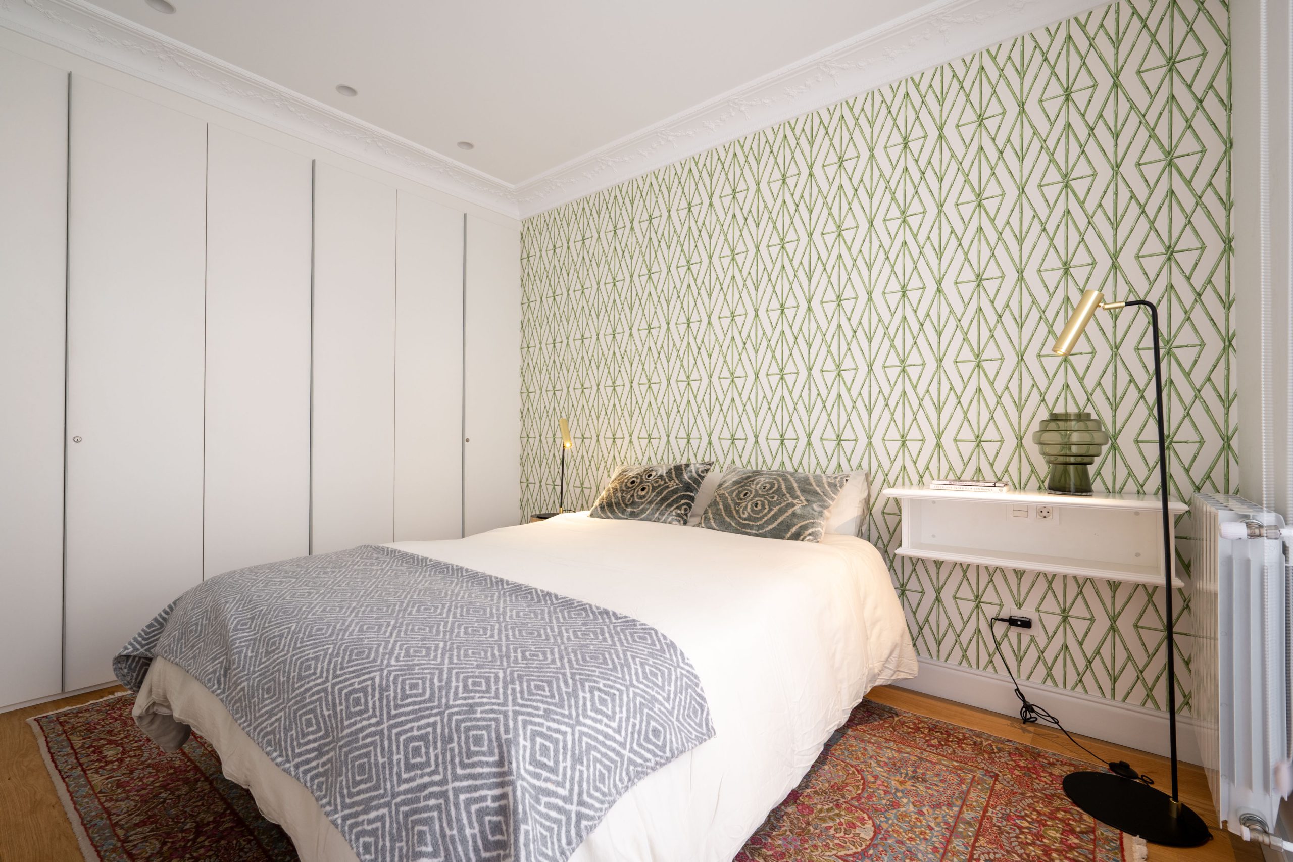 Second bedroom with patterned headboard wall